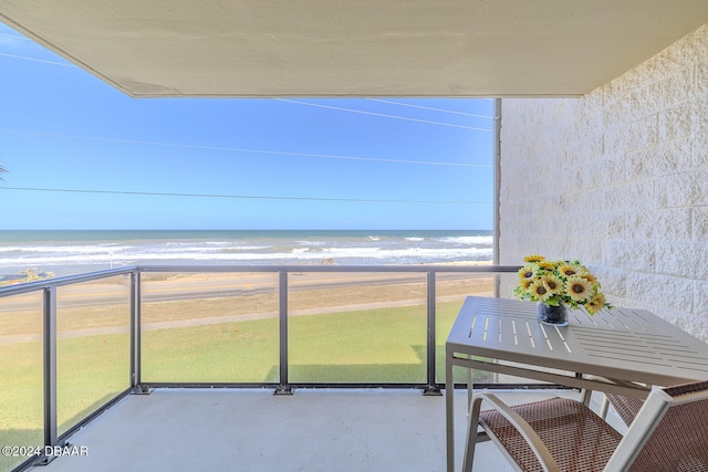 balcony featuring a water view and a view of the beach