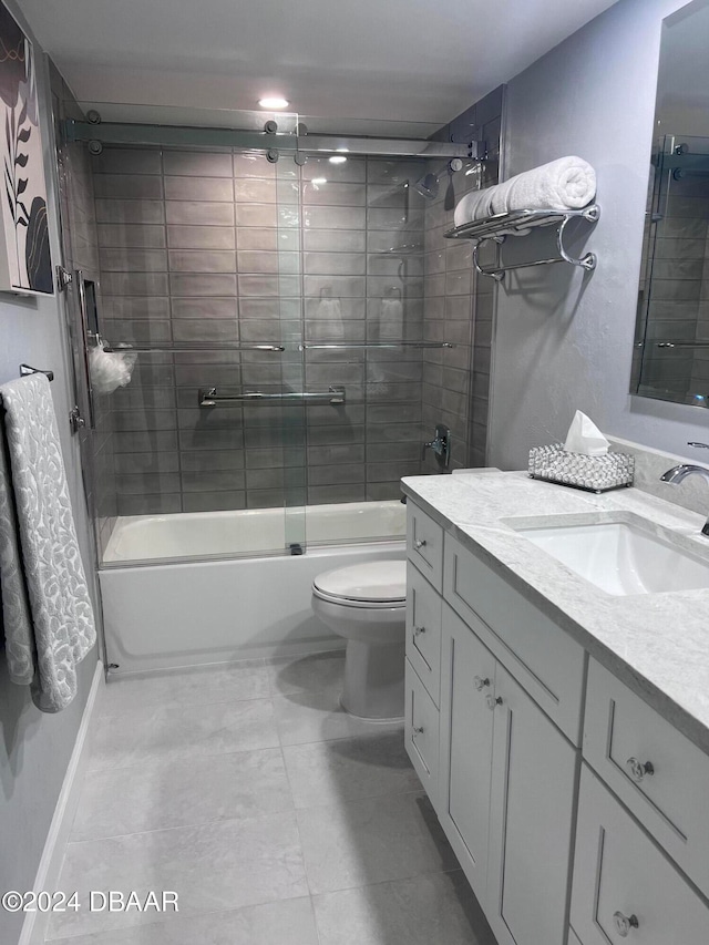 full bathroom featuring vanity, combined bath / shower with glass door, and toilet