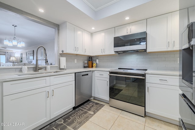 kitchen featuring white cabinetry, sink, light tile patterned floors, and appliances with stainless steel finishes