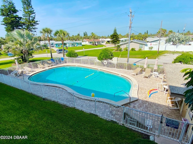 view of swimming pool with a lawn and a patio