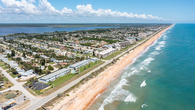 bird's eye view featuring a water view and a beach view