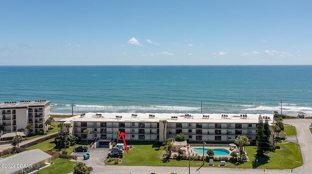 bird's eye view with a water view and a beach view