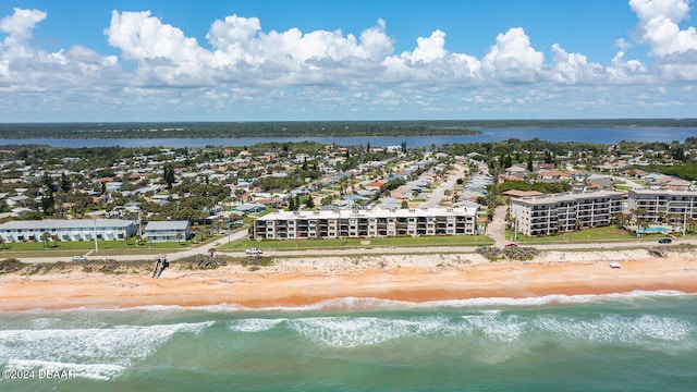 drone / aerial view with a water view and a beach view