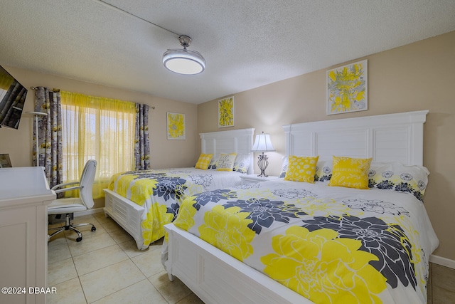 bedroom with light tile patterned floors and a textured ceiling