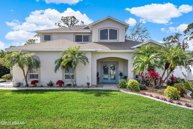 view of front of property featuring french doors and a front lawn