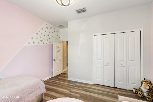 bedroom with hardwood / wood-style floors and a closet