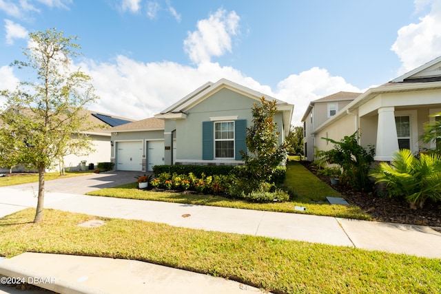 view of front of property featuring a garage and a front yard