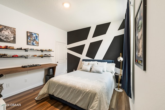 bedroom with dark wood-type flooring