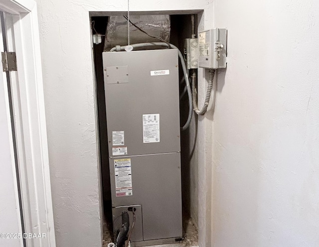 utility room featuring heating unit