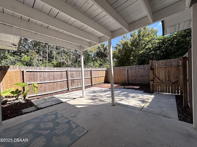 view of patio featuring a fenced backyard and a gate