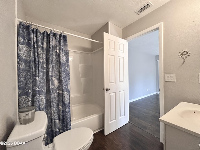 full bathroom featuring vanity, wood finished floors, visible vents, shower / tub combo, and toilet