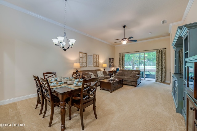 dining room with ceiling fan with notable chandelier, light carpet, and crown molding