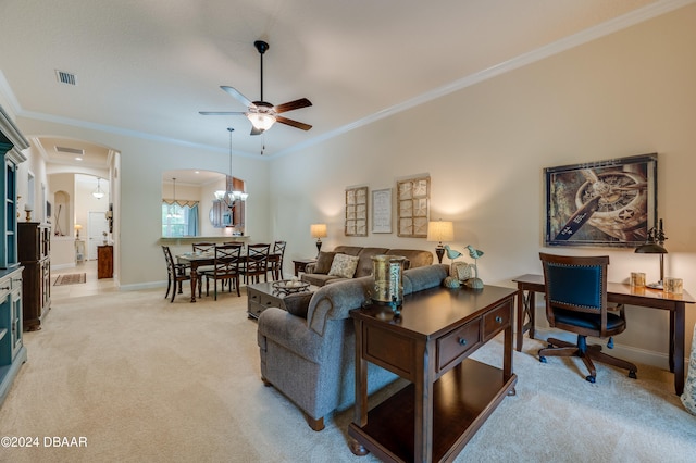 carpeted living room featuring ceiling fan with notable chandelier and ornamental molding