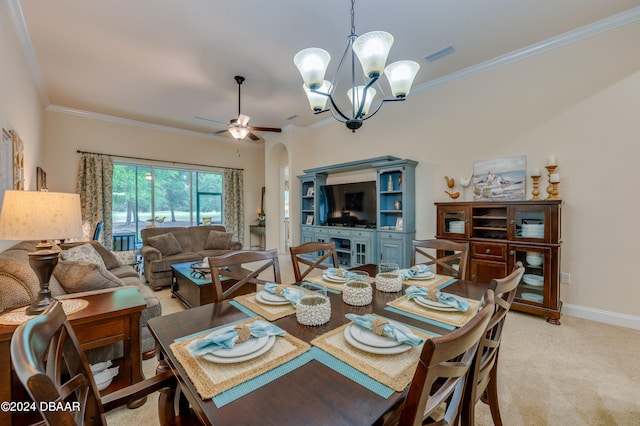 dining room with light colored carpet, ceiling fan with notable chandelier, and ornamental molding