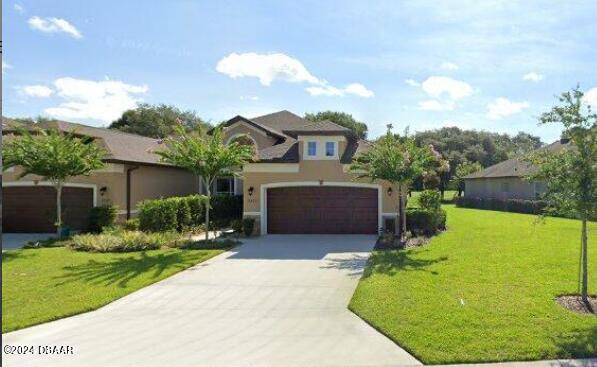 view of front of home with a garage and a front yard