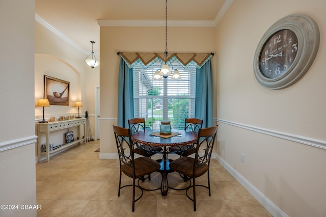 dining area with ornamental molding and a notable chandelier