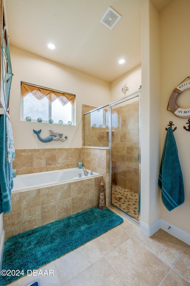 bathroom featuring independent shower and bath and tile patterned flooring