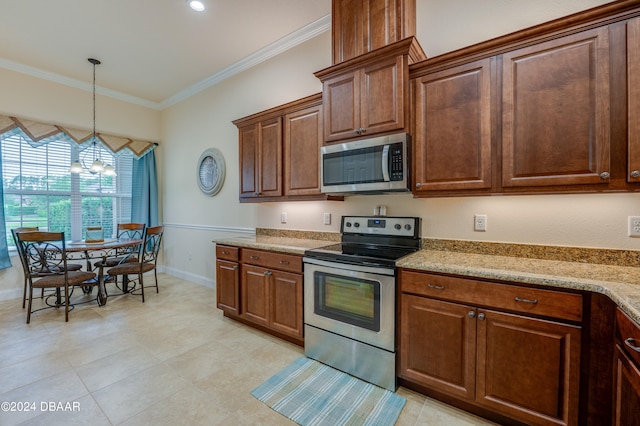 kitchen with a chandelier, appliances with stainless steel finishes, light stone counters, and ornamental molding