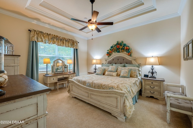 carpeted bedroom featuring a raised ceiling, ceiling fan, and crown molding