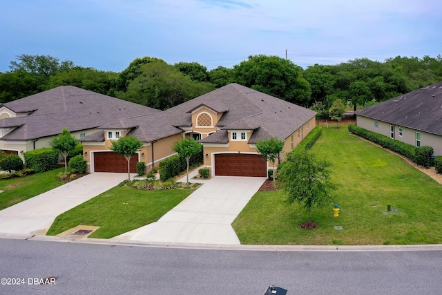 view of front of house featuring a garage and a front lawn