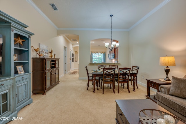 carpeted dining area featuring a chandelier and ornamental molding