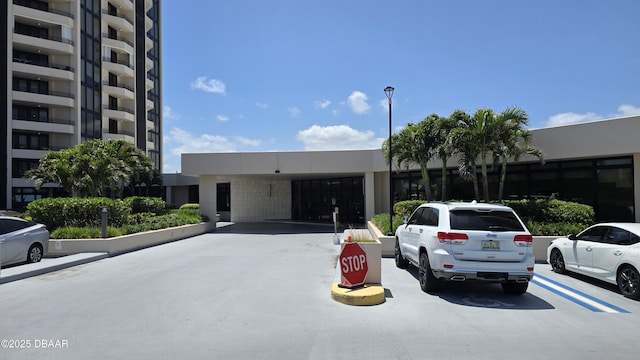 view of property featuring uncovered parking