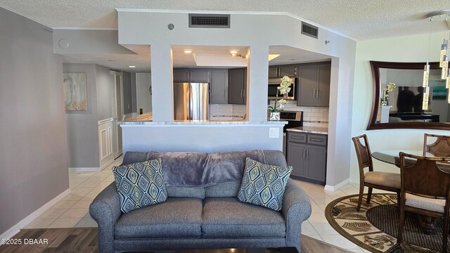 1 Oceans Blvd W Unit 9A3, Daytona Beach, FL 32118 - living area featuring a textured ceiling, visible vents, and ornamental molding