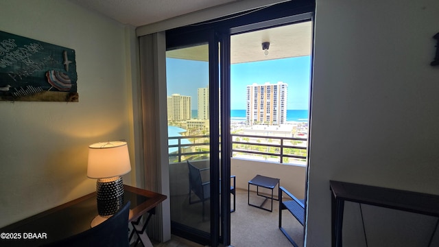 doorway with a view of city and carpet floors
