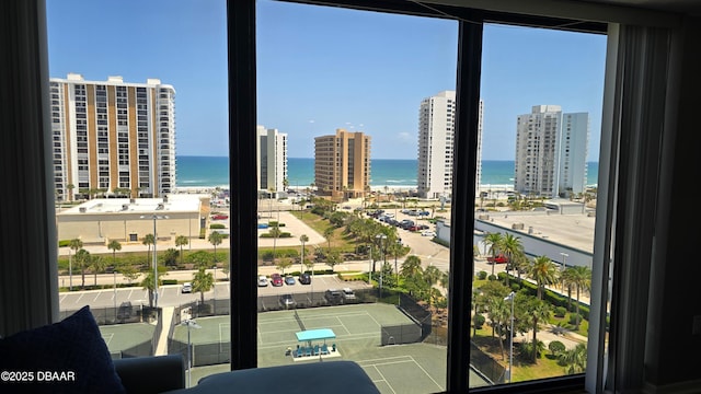 interior space featuring a water view and expansive windows