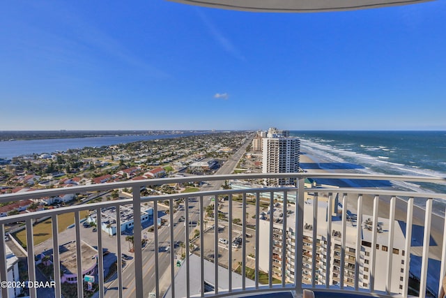 balcony featuring a water view and a beach view