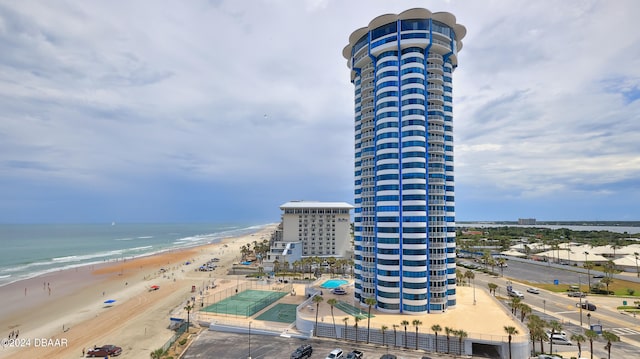 bird's eye view with a water view and a beach view