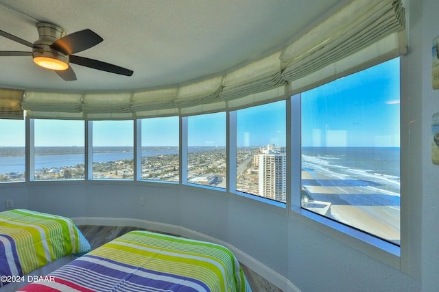 2625 S Atlantic Ave Unit 25Nw, Daytona Beach Shores, FL 32118 - bedroom featuring a water view, wood finished floors, baseboards, a city view, and a textured ceiling