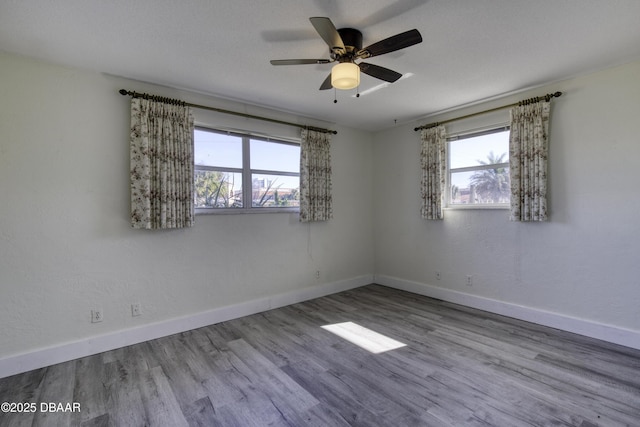 unfurnished room with ceiling fan and light hardwood / wood-style flooring