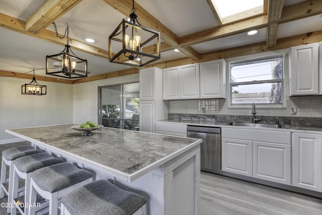 kitchen with pendant lighting, white cabinetry, and a kitchen island