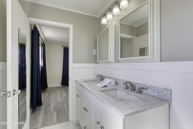 bathroom with hardwood / wood-style floors, vanity, and ornamental molding