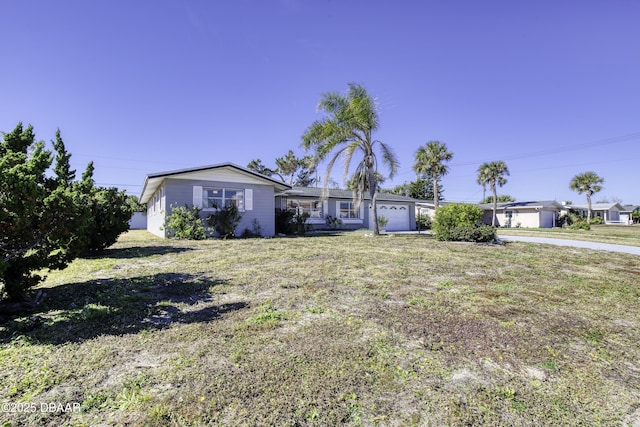 view of front of home with a front yard and a garage