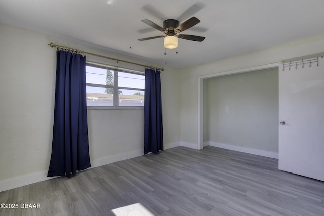 empty room featuring ceiling fan and hardwood / wood-style flooring