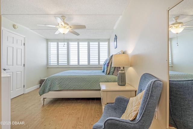 4453 S Atlantic Ave Unit 502, Port Orange, FL 32127 - bedroom with a ceiling fan, a textured ceiling, and wood finished floors