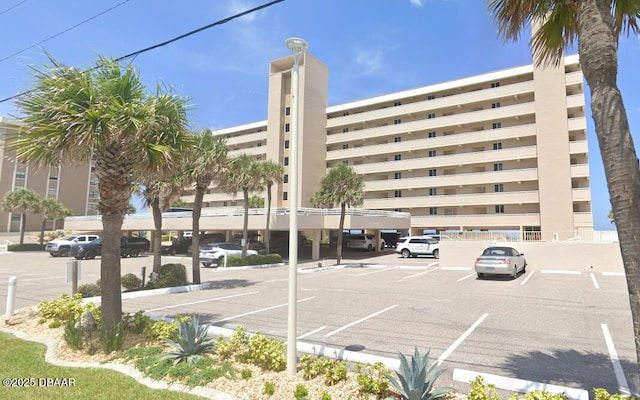 view of building exterior featuring uncovered parking