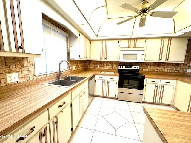 kitchen featuring appliances with stainless steel finishes, cream cabinets, and sink