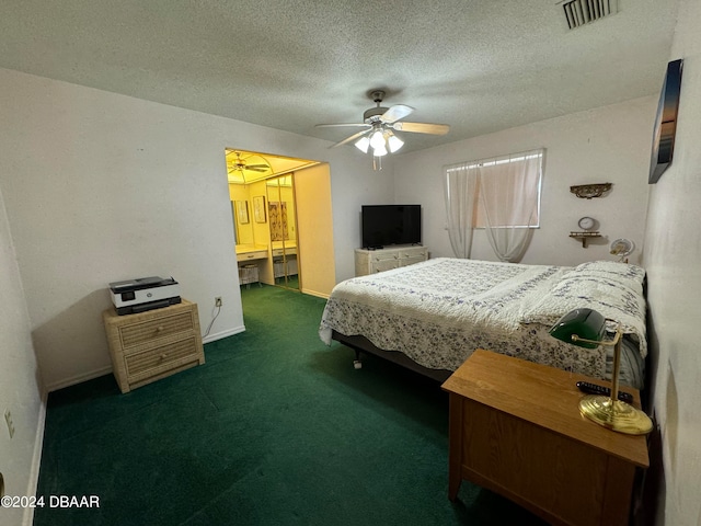 carpeted bedroom with ensuite bath, ceiling fan, and a textured ceiling