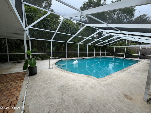 view of swimming pool with a lanai and a patio area