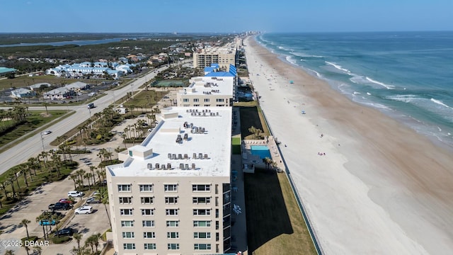 bird's eye view featuring a water view and a beach view