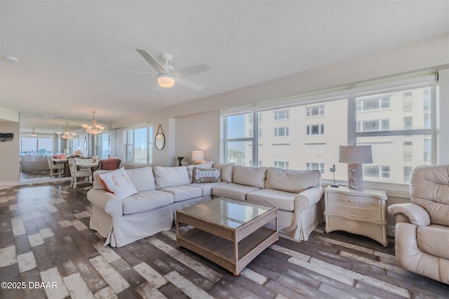 living room featuring dark hardwood / wood-style floors and ceiling fan with notable chandelier