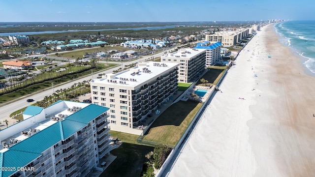 birds eye view of property with a view of the beach and a water view