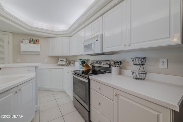 kitchen with ornamental molding, light tile patterned floors, stainless steel range with electric cooktop, and white cabinets