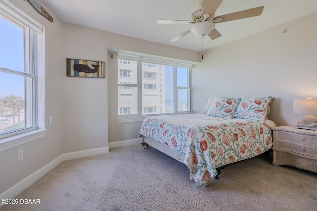 bedroom featuring light carpet and ceiling fan