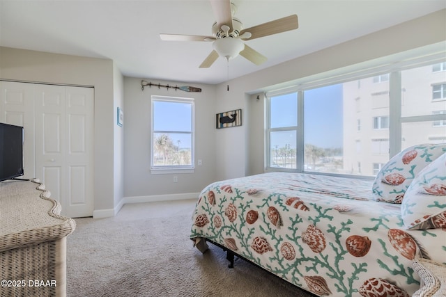 bedroom featuring ceiling fan, light colored carpet, and a closet