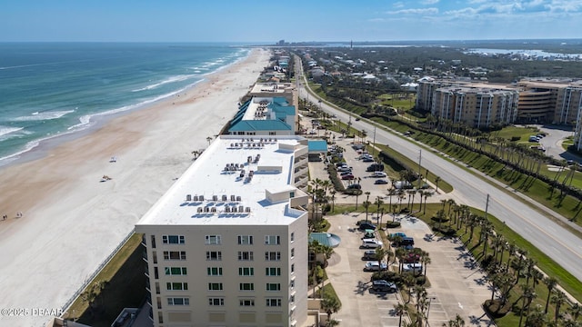 birds eye view of property featuring a view of the beach and a water view