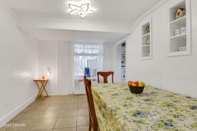 tiled dining area featuring built in features